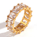 Gold ring with clear gemstones on a white background