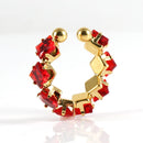 Gold hoop earrings with red gemstones on a white background