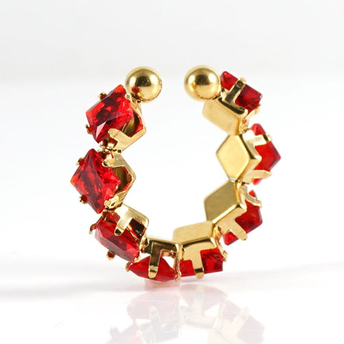 Gold hoop earrings with red gemstones on a white background
