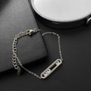 Silver bracelet with a decorative clasp on a dark surface