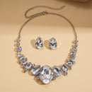Jewelry set with necklace and earrings on a beige background