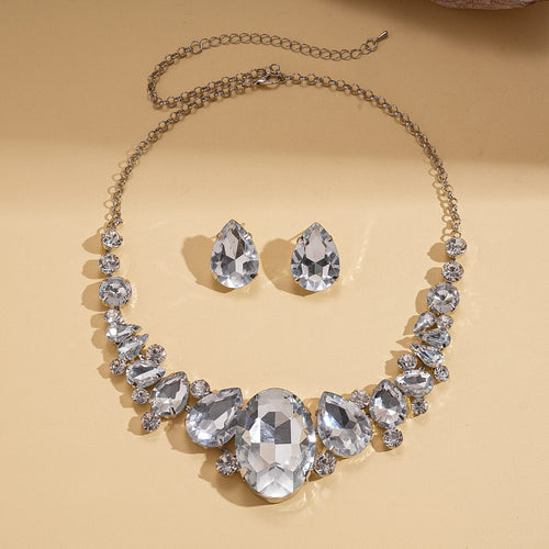 Jewelry set with necklace and earrings on a beige background