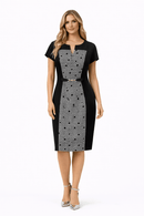Woman wearing a black and white patterned dress on a white background