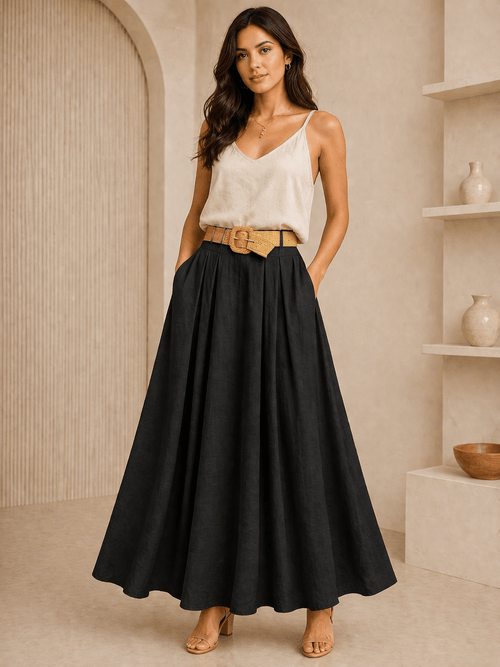 Woman wearing a white top and black skirt in a neutral setting