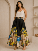 Woman wearing a colorful skirt with a scenic design in a neutral setting
