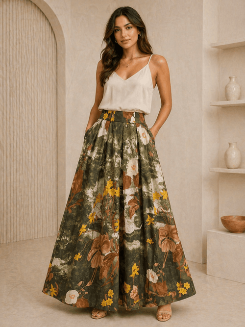 Woman wearing a white top and floral skirt in a neutral setting