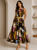 Woman wearing a colorful sleeveless dress with a belt in a neutral setting