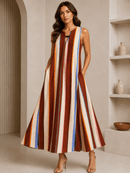 Woman wearing a colorful striped dress in an indoor setting.