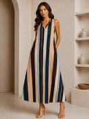 Woman wearing a long, multicolored striped dress in an indoor setting.