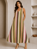 Woman wearing a striped dress in a neutral setting