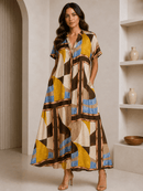 Woman wearing a patterned dress standing in a room with shelves and decor.