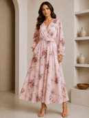 Woman wearing a pink floral dress in a neutral setting