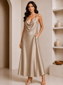 Woman wearing a gold satin dress in an elegant interior setting