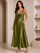 Woman wearing a green satin dress in an indoor setting