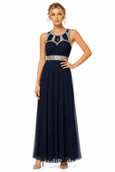Woman wearing a navy evening gown with silver embellishments on a white background