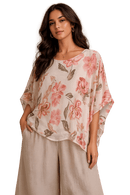 Woman wearing a floral blouse with a black background